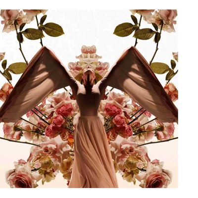 A person in a light pink dress with large flowing sleeves stands with arms outstretched upwards among symmetrically arranged pink roses and yellow orchids.