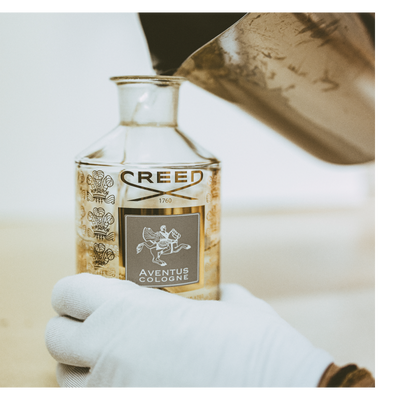 Liquid is poured from a bottle with the text CREE into a beaker containing dark liquid while a pipette is held above.